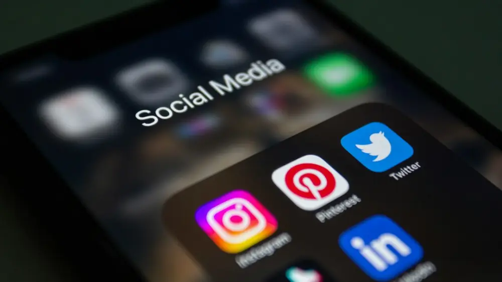 A close up of a cell phone with social media icons on it, illustrating app experience